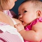 baby sucking on mum's breast