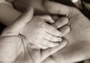 Parents and baby hand in hand