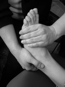 man giving woman a foot massage