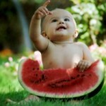 baby sitting with a watermelon