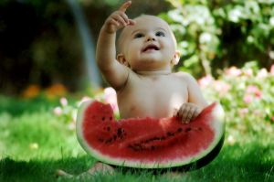 baby sitting with a watermelon