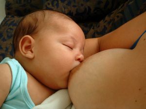 baby breastfeeding from his mother