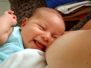 Woman nursing a happy baby