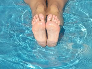 woman flexing toes to alleviate cramp in her calf